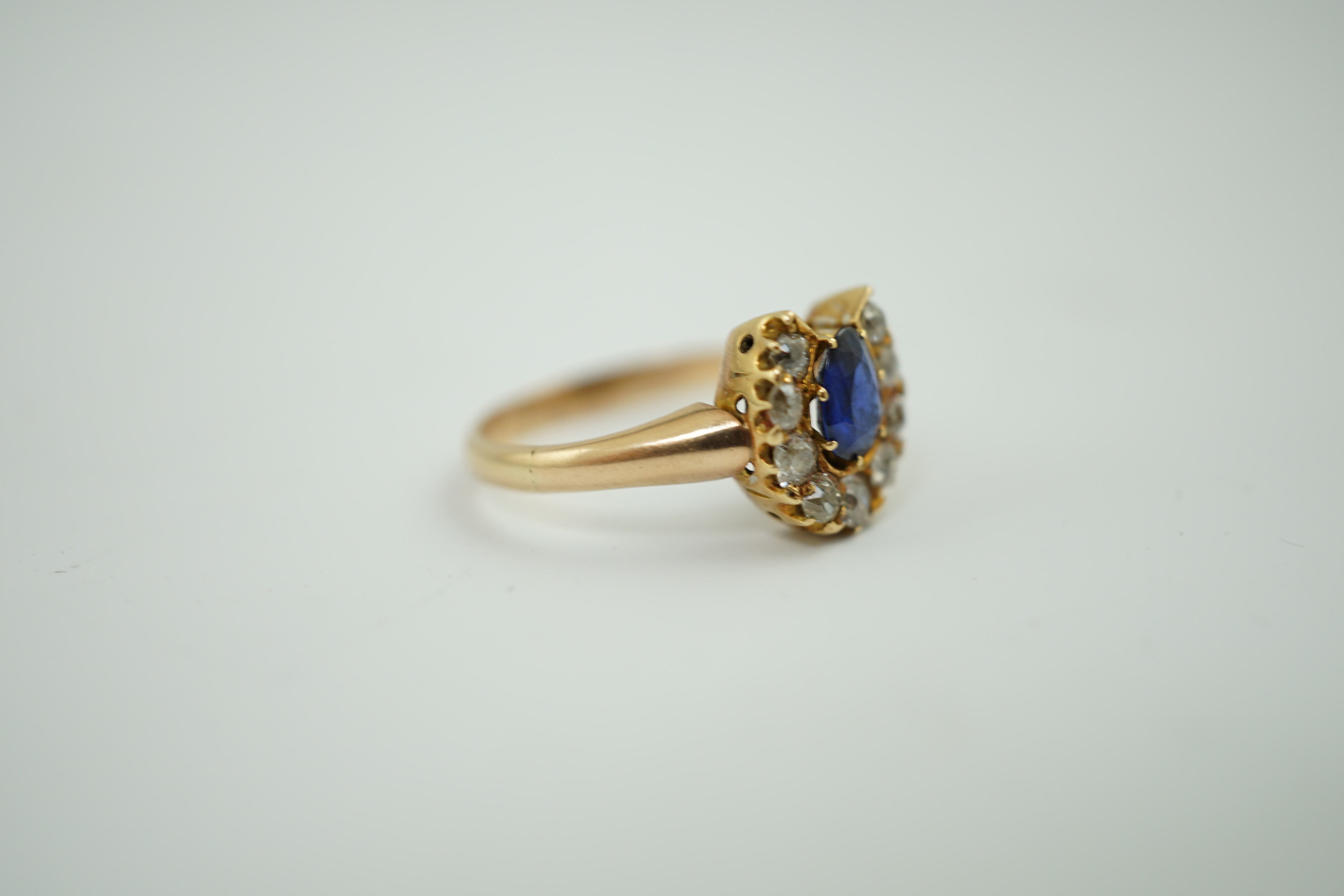 An early to mid 20th century gold, sapphire and diamond set horseshoe cluster ring